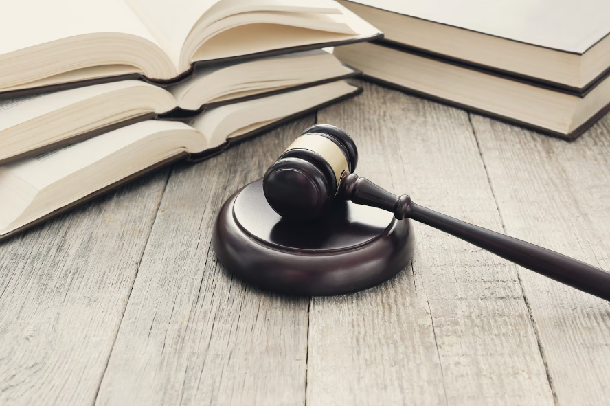 Court Hammer and books on a white wood table